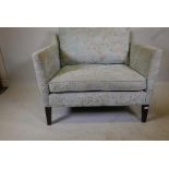 A Wesley Barrell love seat with floral upholstery