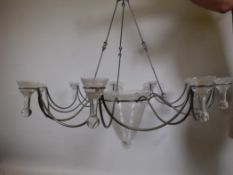 A contemporary steel eight branch chandelier with glass bowls, 42" diameter