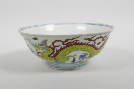 A Chinese doucai porcelain bowl decorated with dragons, six character mark to base, 7" diameter