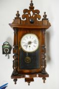 A late C19th American wall clock by the Ansonia Clock Company, New York, turned walnut with Gothic