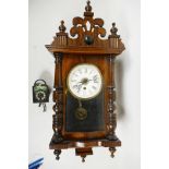 A late C19th American wall clock by the Ansonia Clock Company, New York, turned walnut with Gothic