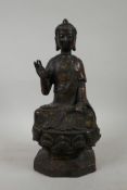 A Chinese bronzed metal figure of Buddha seated on a lotus throne, seal mark verso, 12½" high