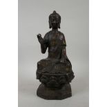 A Chinese bronzed metal figure of Buddha seated on a lotus throne, seal mark verso, 12½" high