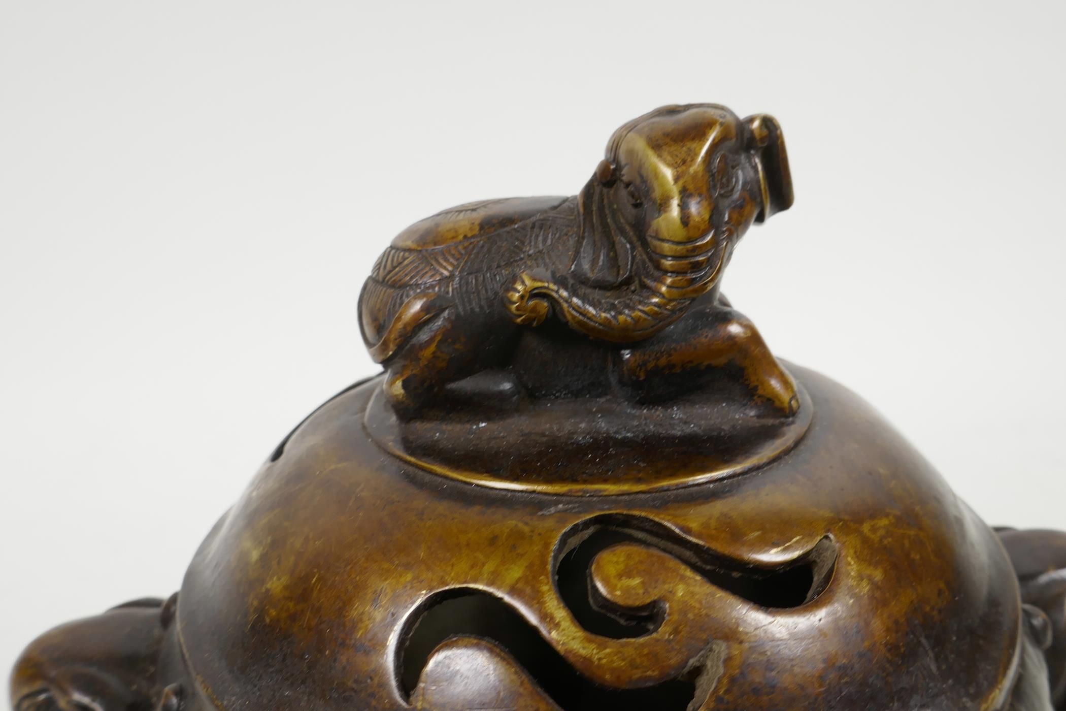 A Chinese bronze barrel shaped censer with two elephant mask handles and elephant knop, raised on - Image 4 of 5