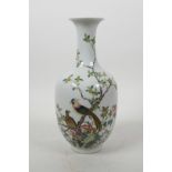 A Chinese polychrome porcelain vase decorated with birds perched on a tree in bloom, seal mark to