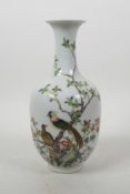 A Chinese polychrome porcelain vase decorated with birds perched on a tree in bloom, seal mark to