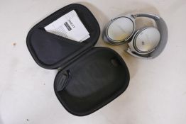 A pair of Bose Quiet Comfort 35 Bluetooth headphones in case