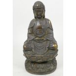 A Chinese cast bronze figure of Buddha seated in meditation on a lotus throne, 8½" high
