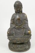 A Chinese cast bronze figure of Buddha seated in meditation on a lotus throne, 8½" high