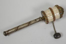 A Tibetan brass and carved bone prayer spinner with turquoise and coral bead decoration, 7" long