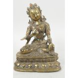 A bronze figure of Green Tara seated in meditation, studded with turquoise and coral beads, 6½" high