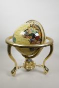 A brass and composition terrestrial globe, the countries set with semi-precious stones, 12"