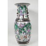 A Chinese stoneware porcelain vase decorated with many figures in a continuous landscape in bright