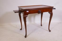 A Georgian style mahogany slider table, with pull out end slides and tray top, raised on carved