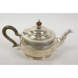 A hallmarked silver teapot with wooden handle and knop, gross 484 grams, marks rubbed