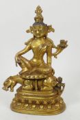 A Sino-Tibetan bronze figure of a deity seated on a mythical beast, double vajra mark to base, 8"