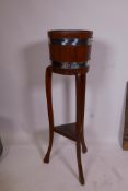 An R.A. Lister and Co Ltd metal bound oak jardiniere, 36" high