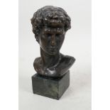A classical style bronze bust of a young man on a square base, 7" high