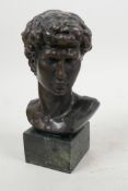 A classical style bronze bust of a young man on a square base, 7" high