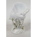 A Belleek style white lustre glazed snail shell vase supported on branches and dragonflies, 5½"
