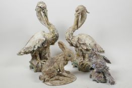 Two studio pottery models of storks, 11" high, together with a smaller figure of a bird of prey