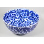 A large blue and white porcelain bowl with scrolling floral decoration, 14" diameter