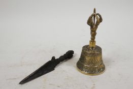 A Tibetan brass bell with a vajra handle, together with a small cast iron Tibetan phurba, 5" long