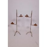 A pair of wrought iron two branch candlesticks, 28" high