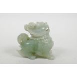 A Chinese carved green jade box and cover in the form of a kylin, 3" high