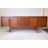 A G Plan teak sideboard, with two cupboards flanking a flight of four drawers, 85" x 18" x 33"