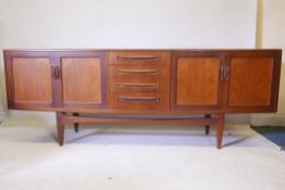 A G Plan teak sideboard, with two cupboards flanking a flight of four drawers, 85" x 18" x 33"