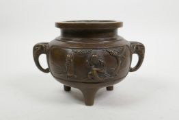 A Chinese bronze censer on tripod feet with elephant mask handles, impressed 4 character mark to