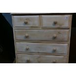 A whitewashed pine chest of two over three moulded drawers, raised on a plinth base, 36" x 16" x 38"