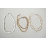 Two multi-strand pearl necklaces, one A/F, and a string of shell beads, 16" long