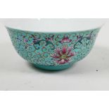 A Chinese porcelain rice bowl painted with bats and flowers on a turquoise ground, 5¼" diameter