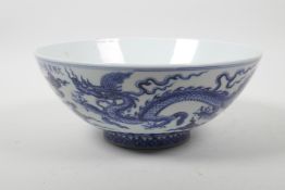 A Chinese blue and white porcelain bowl decorated with two dragons, 6 character mark to lip, 9"