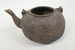 An Oriental gilt bronze teapot with dimpled decoration, no lid, 6½" long