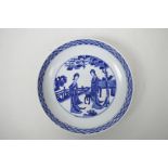 A Chinese blue and white porcelain dish decorated with women in a garden, 6 character mark to