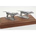 Two silver plated 'setter' dog car mascots mounted on a wooden base, 10½" long