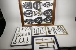 Five display boards of kitchen wares, iron stands, corkscrew, nutcrackers, confectioner's hammer and