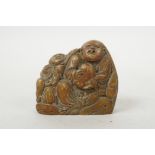 A Chinese soapstone carving of two figures and a peach, 2½" wide
