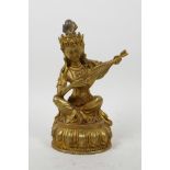 A Sino-Tibetan gilt bronze of a musician on a lotus throne, impressed double vajra mark to base, 8½"