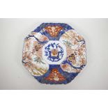 A Japanese Imari octagonal serving plate decorated in the traditional palette, 12" diameter