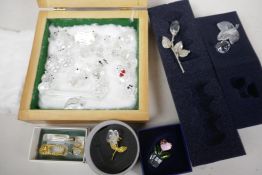 A quantity of boxed and loose Swarovski Crystal figurines of animals, birds, flowers etc