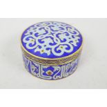 An Islamic cloisonne trinket box decorated with flowers and symbols, 3" diameter