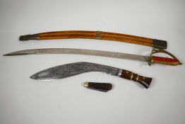An Oriental Indian sword in velvet covered scabbard, 27½" long together with a wood and brass