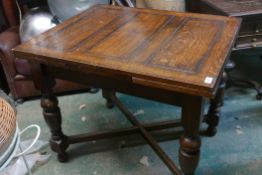 A 1930 oak drawleaf table, raised on turned supports united by a cross stretcher, 30" x 36" x 60"