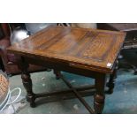 A 1930 oak drawleaf table, raised on turned supports united by a cross stretcher, 30" x 36" x 60"