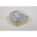 A Chinese white metal trinket box, the lid set with a polychrome porcelain shard depicting a lady,