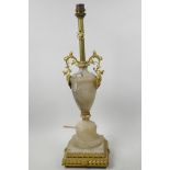 A gilt metal and alabaster table lamp in the form of a classical urn on square stepped pedestal, 19"
